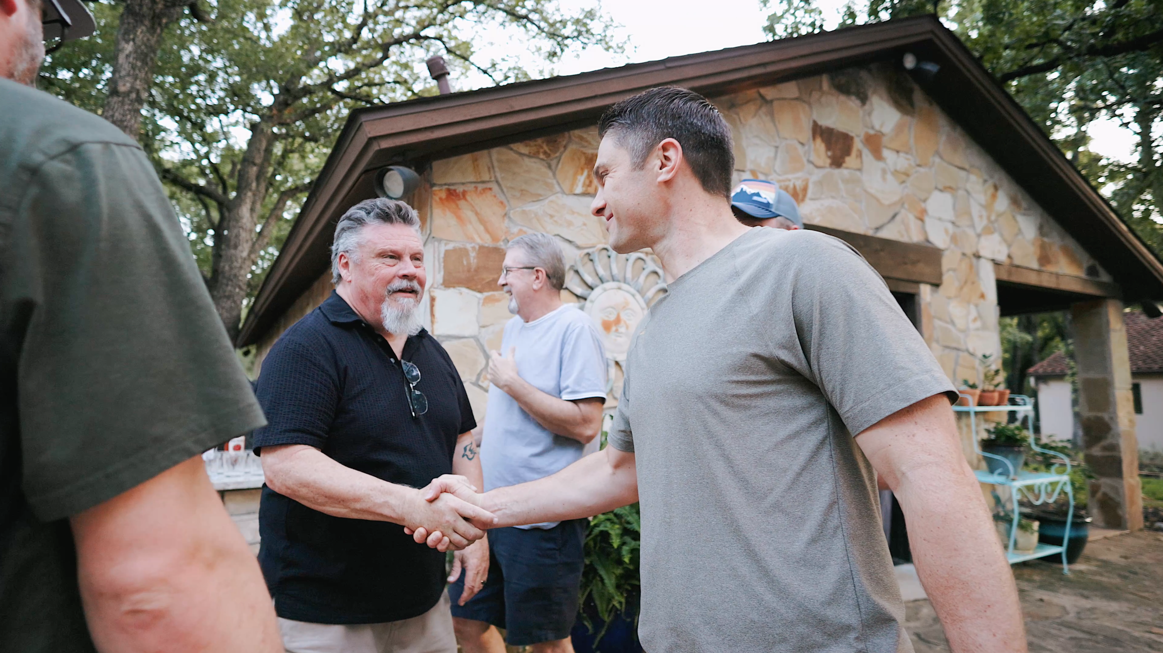 Brent Lamb shaking hands at mens retreat